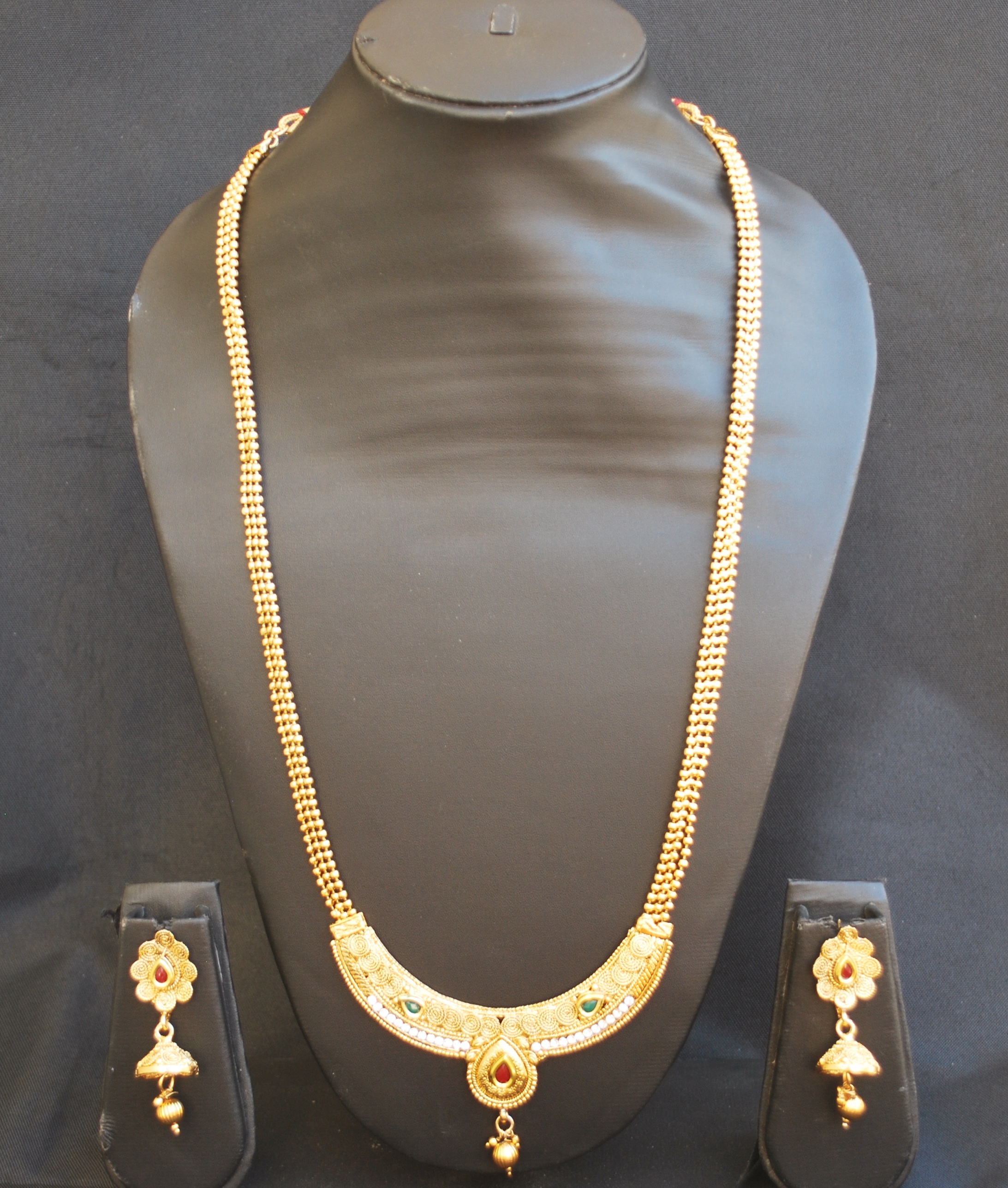 long gold necklace with stones