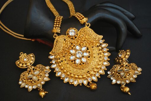 Imitation artificial studded white stone golden long necklace set